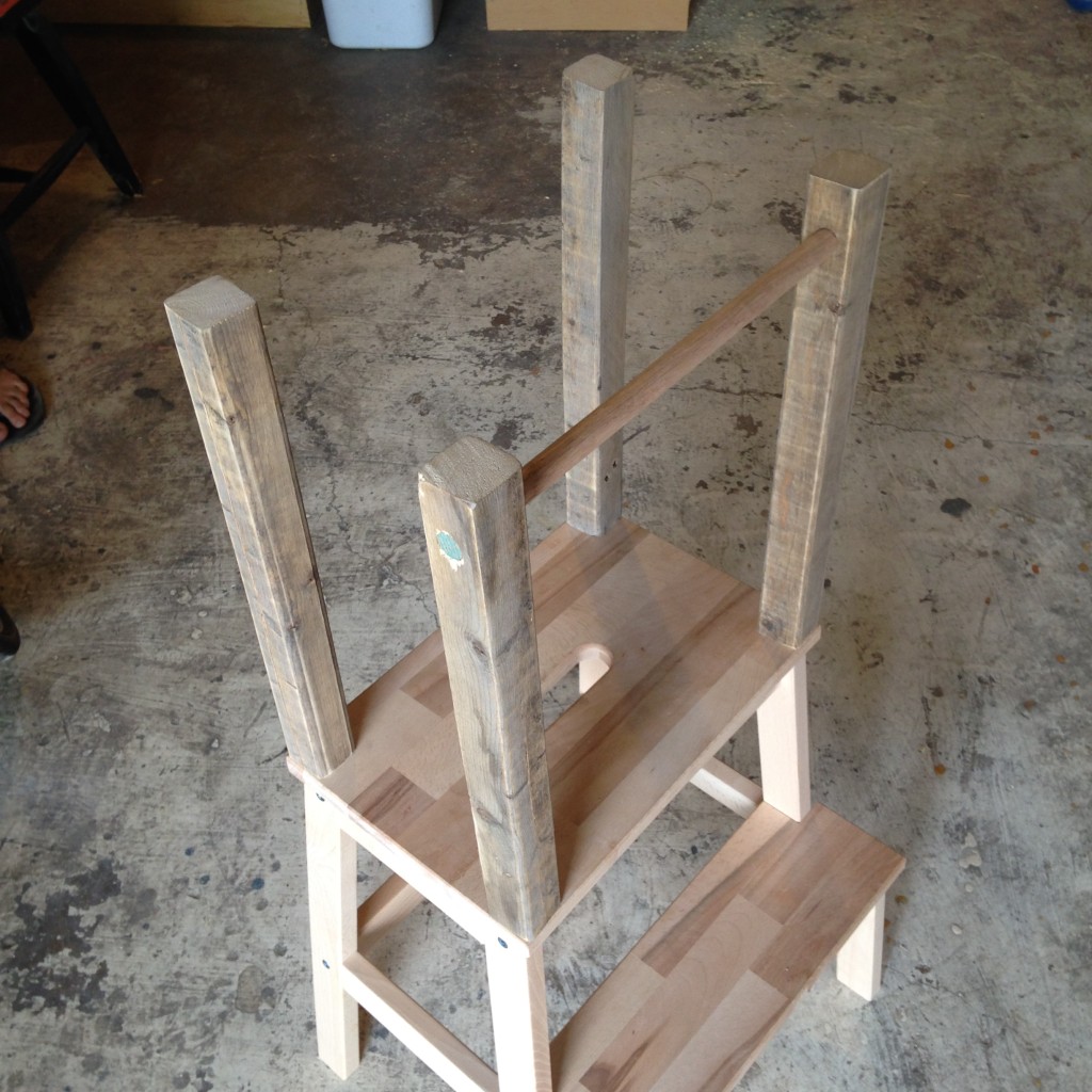With the uprights attached to the platform, we then screwed the platform back onto the stool and ran the dowel through the 5/8" holes.
