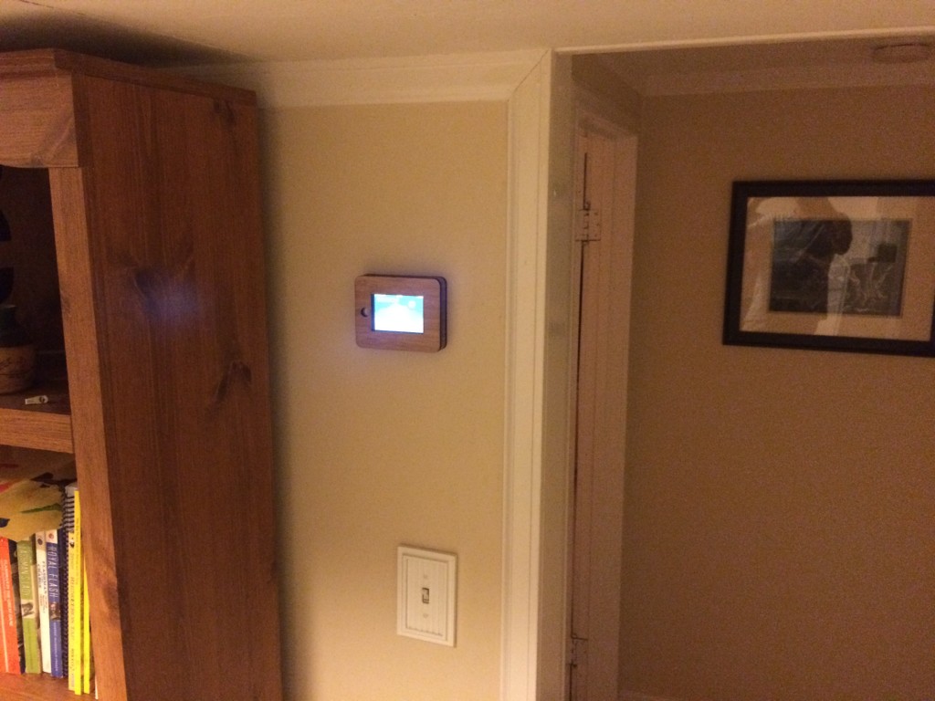 The iPhone 4 frame mounted in a high traffic area, providing an easy readout of house status.