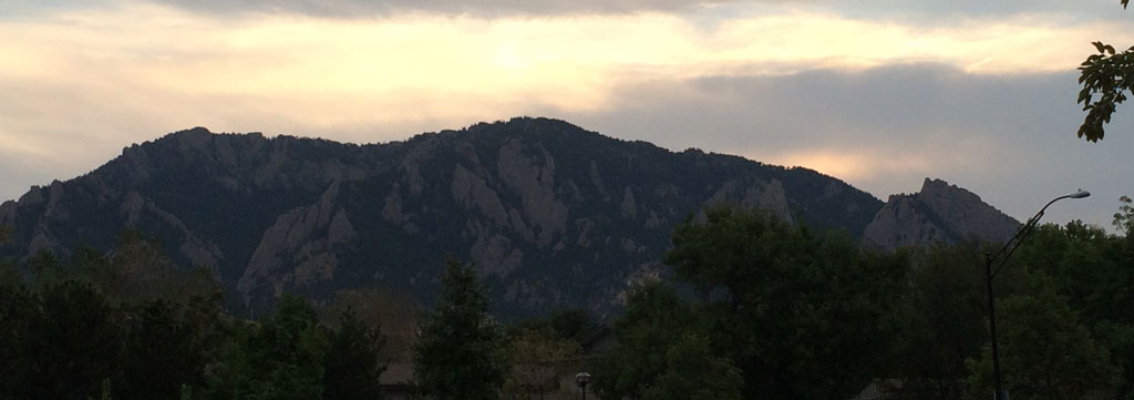 A sunset picture of the Boulder Flatirons from our backyard. Notice how the mountains become backlit once the sun sets.
